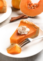 Photo of Plate with piece of fresh delicious homemade pumpkin pie on light table