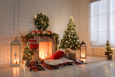 Beautiful Christmas themed photo zone with fireplace and fir decor