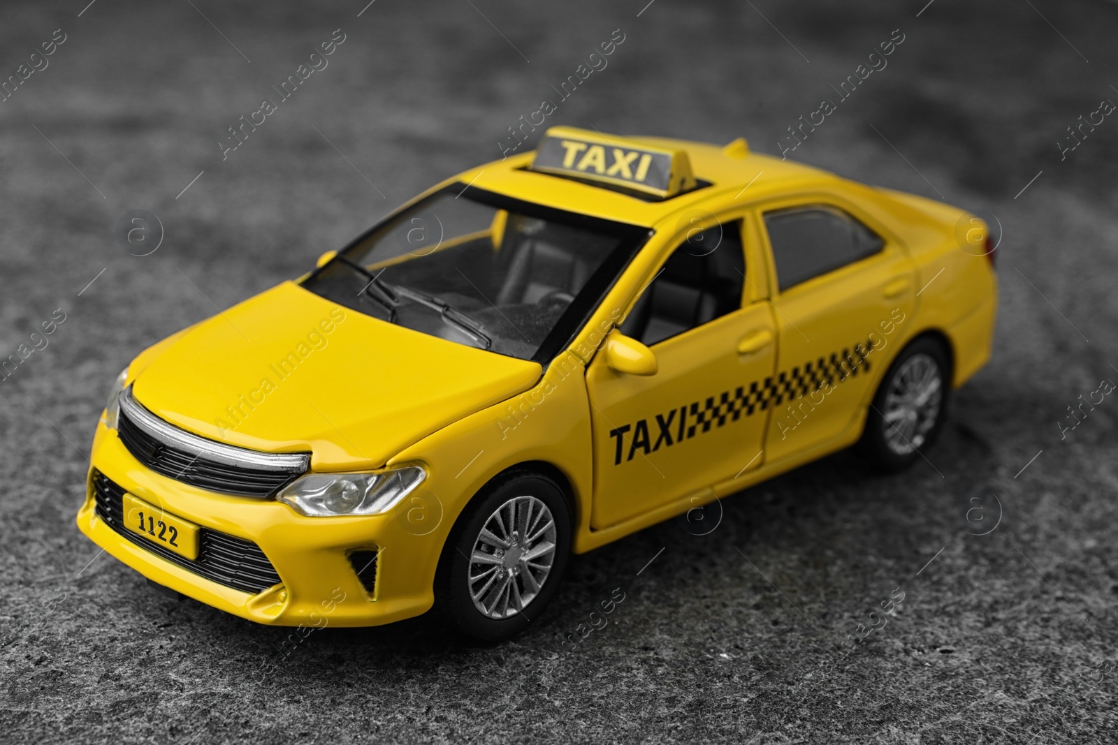 Photo of Yellow taxi car model on grey background