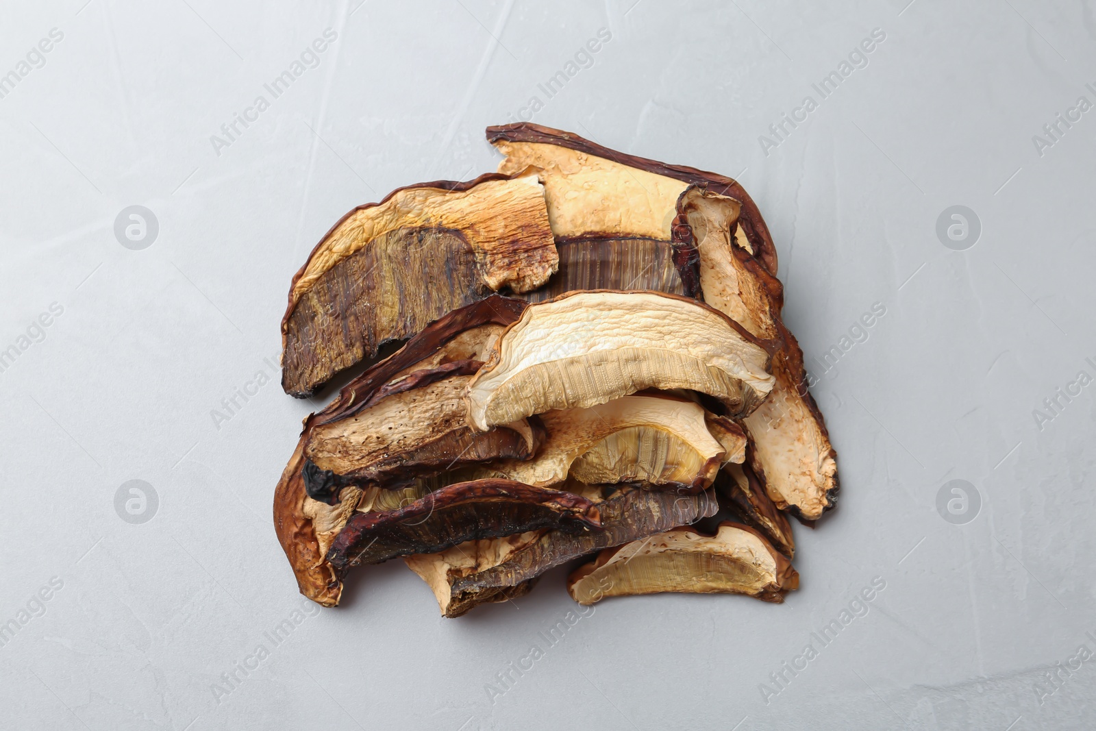 Photo of Dried mushrooms on color background, top view