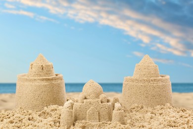 Image of Sand castles on ocean beach. Outdoor play