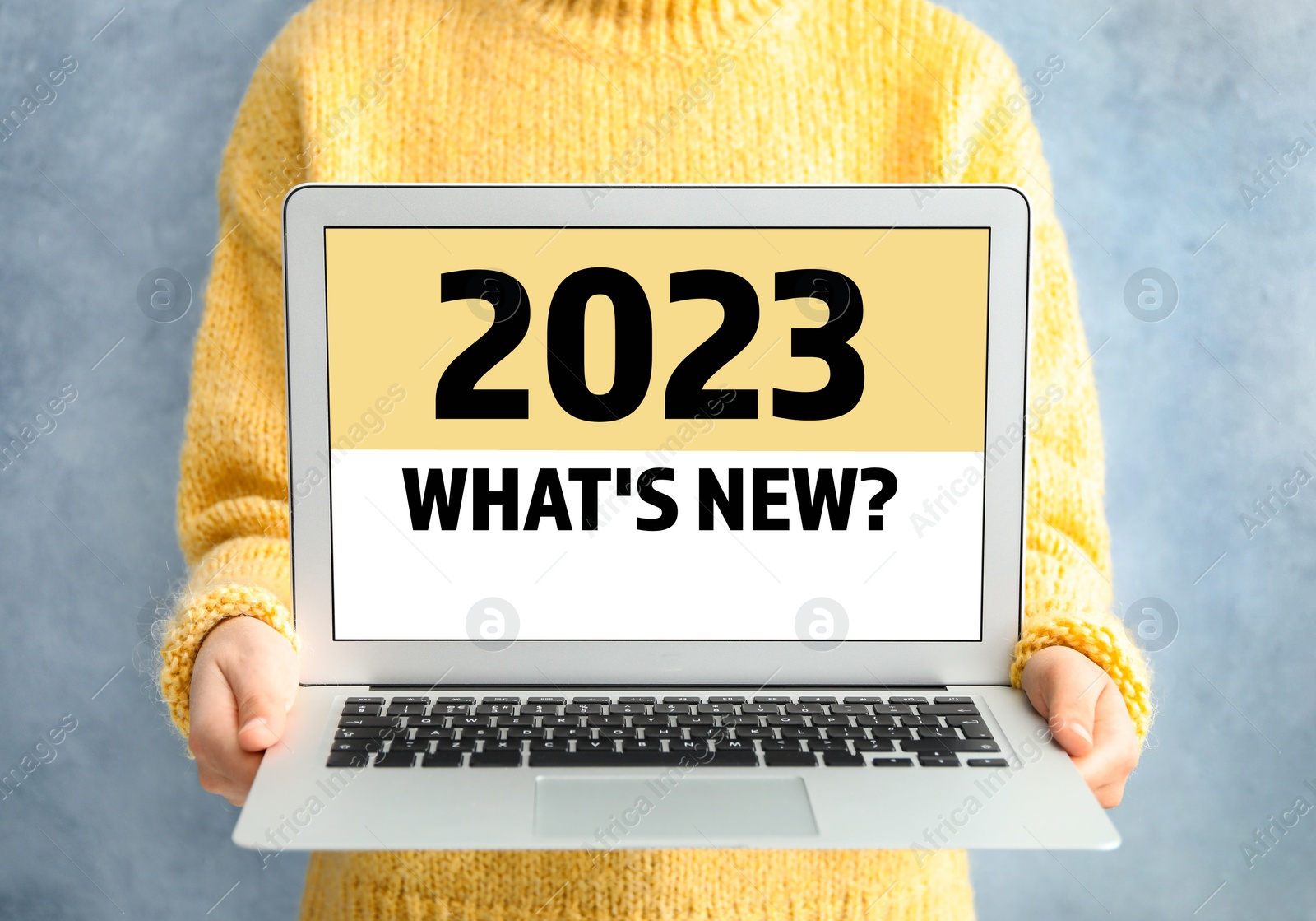 Image of Future trends. 2023 What's New? text on laptop display. Woman holding device, closeup