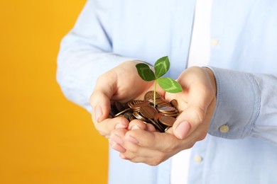 Photo of Woman holding coins with green sprout on yellow background, closeup. Investment concept