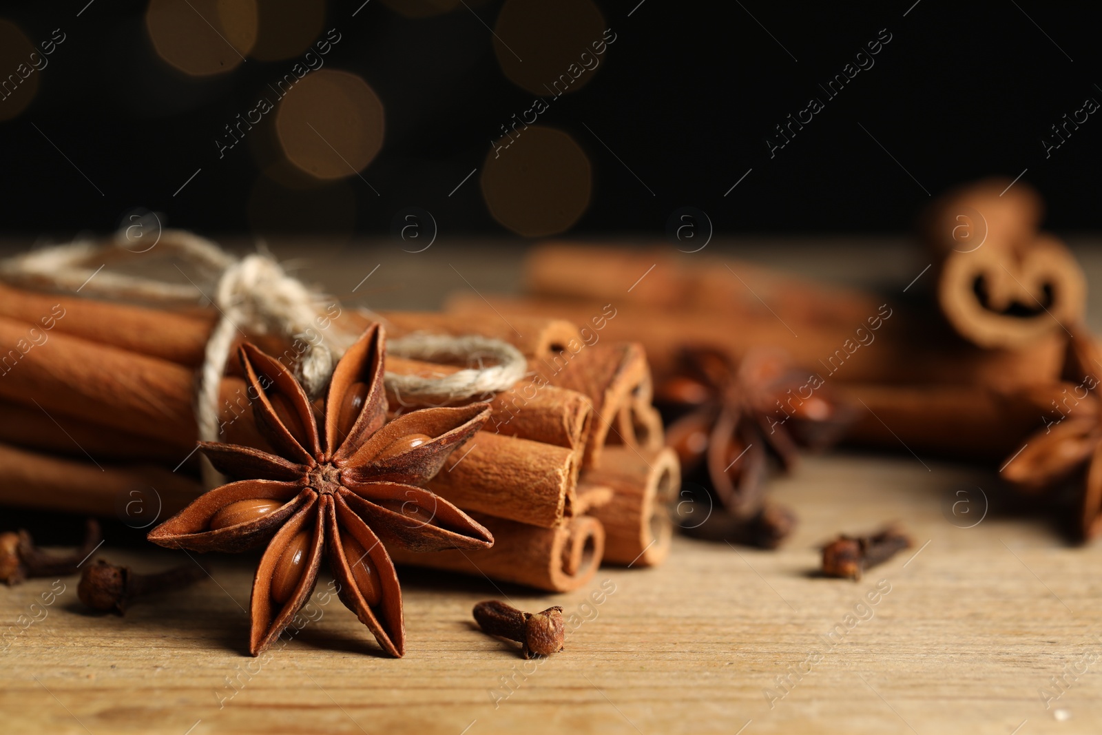 Photo of Different aromatic spices on wooden table, closeup