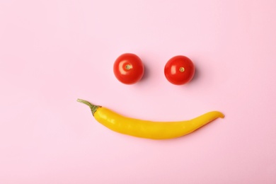 Photo of Funny flat lay composition with cherry tomatoes and chili pepper on color background