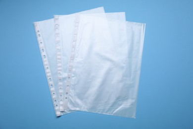 Punched pockets on light blue background, flat lay