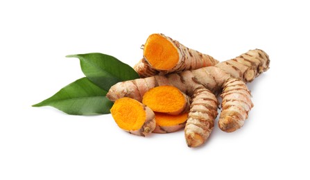 Photo of Fresh turmeric roots and green leaves isolated on white