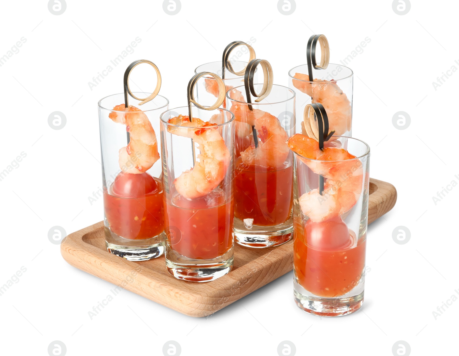 Photo of Tasty canapes with shrimps, tomatoes and sauce in shot glasses isolated on white