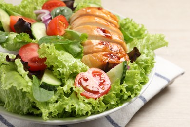 Photo of Delicious salad with chicken and vegetables on table, closeup