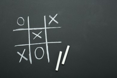 Photo of Tic tac toe game drawn on chalkboard, top view