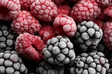 Photo of Tasty frozen raspberries and blackberries as background, top view