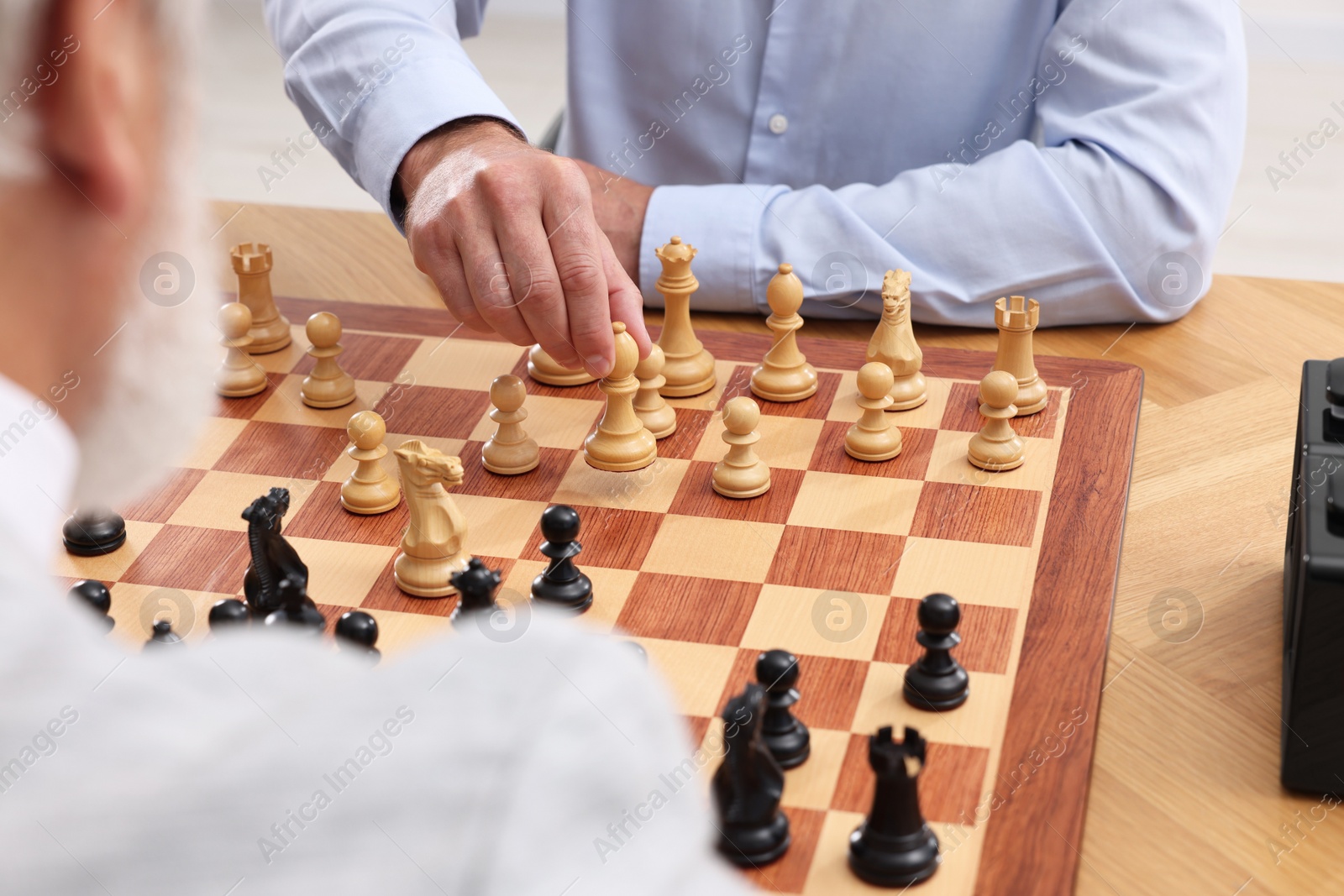 Photo of Men playing chess during tournament at table, closeup