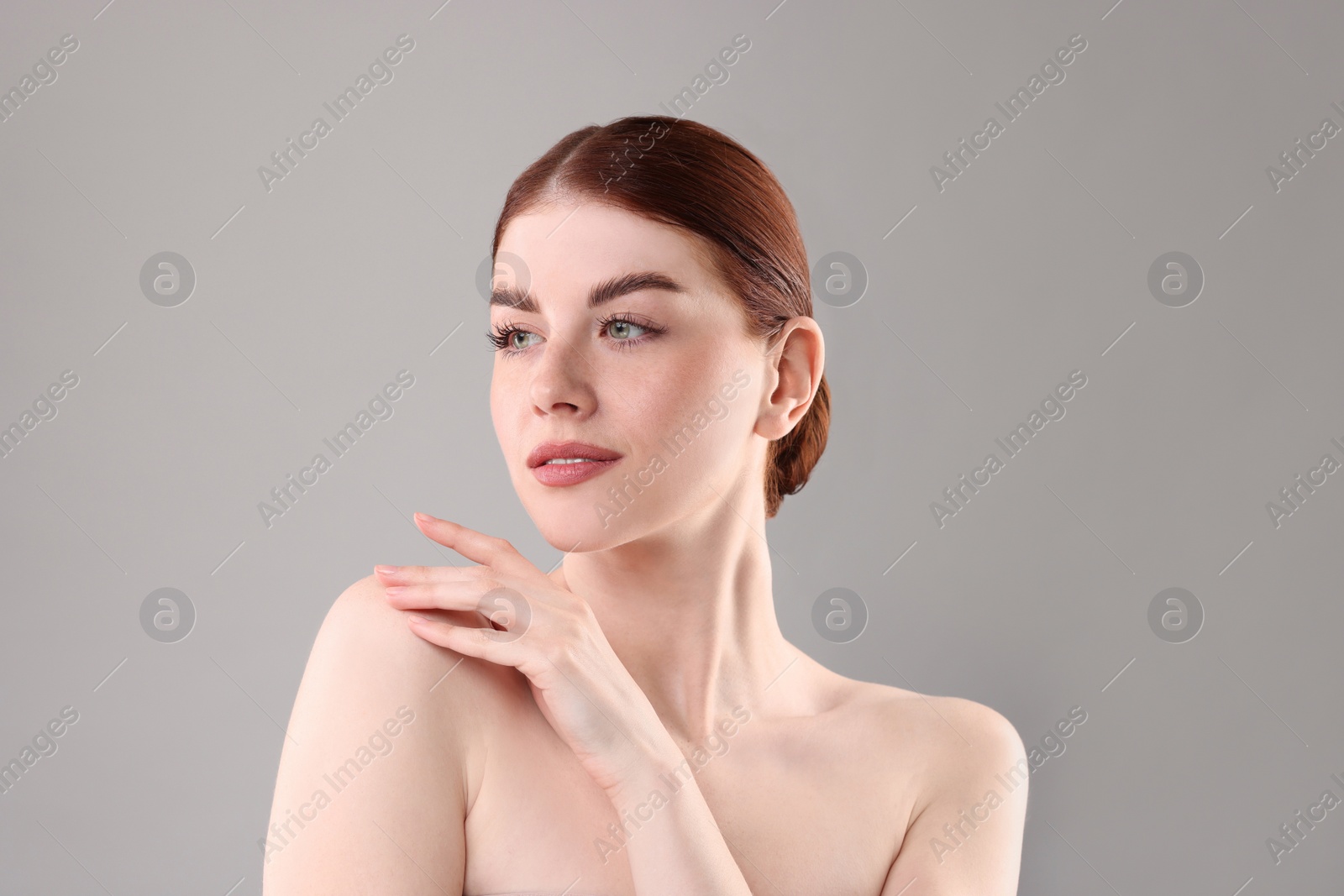 Photo of Portrait of beautiful woman on grey background