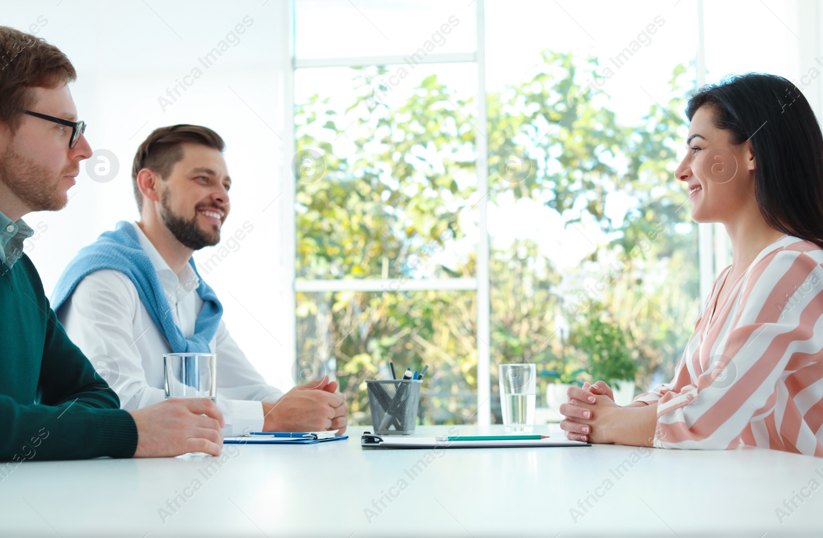 Photo of Human resources manager conducting job interview with applicants in office