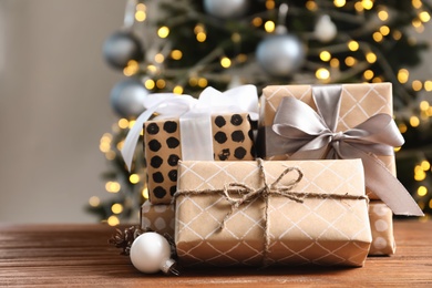 Beautiful gift boxes and blurred Christmas tree on background