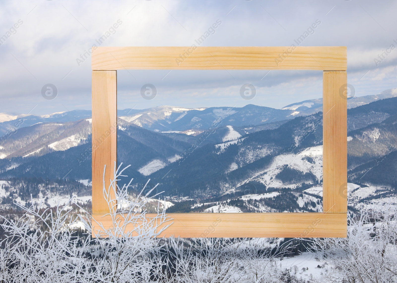 Image of Wooden frame and beautiful mountains covered with snow in winter