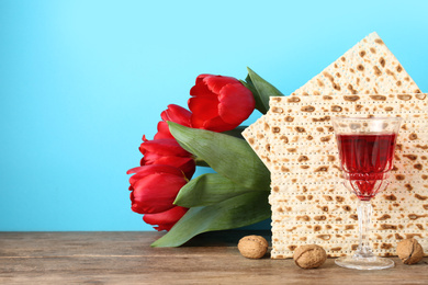 Photo of Composition with Passover matzos on wooden table, space for text. Pesach celebration