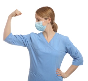 Photo of Doctor with protective mask showing muscles on white background. Strong immunity concept