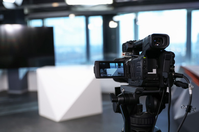 Photo of Modern video recording studio with professional equipment, focus on camera