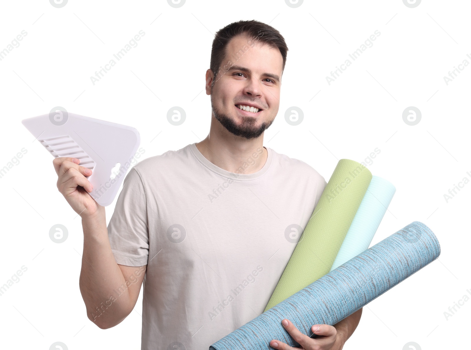 Photo of Man with wallpaper rolls and spatula on white background