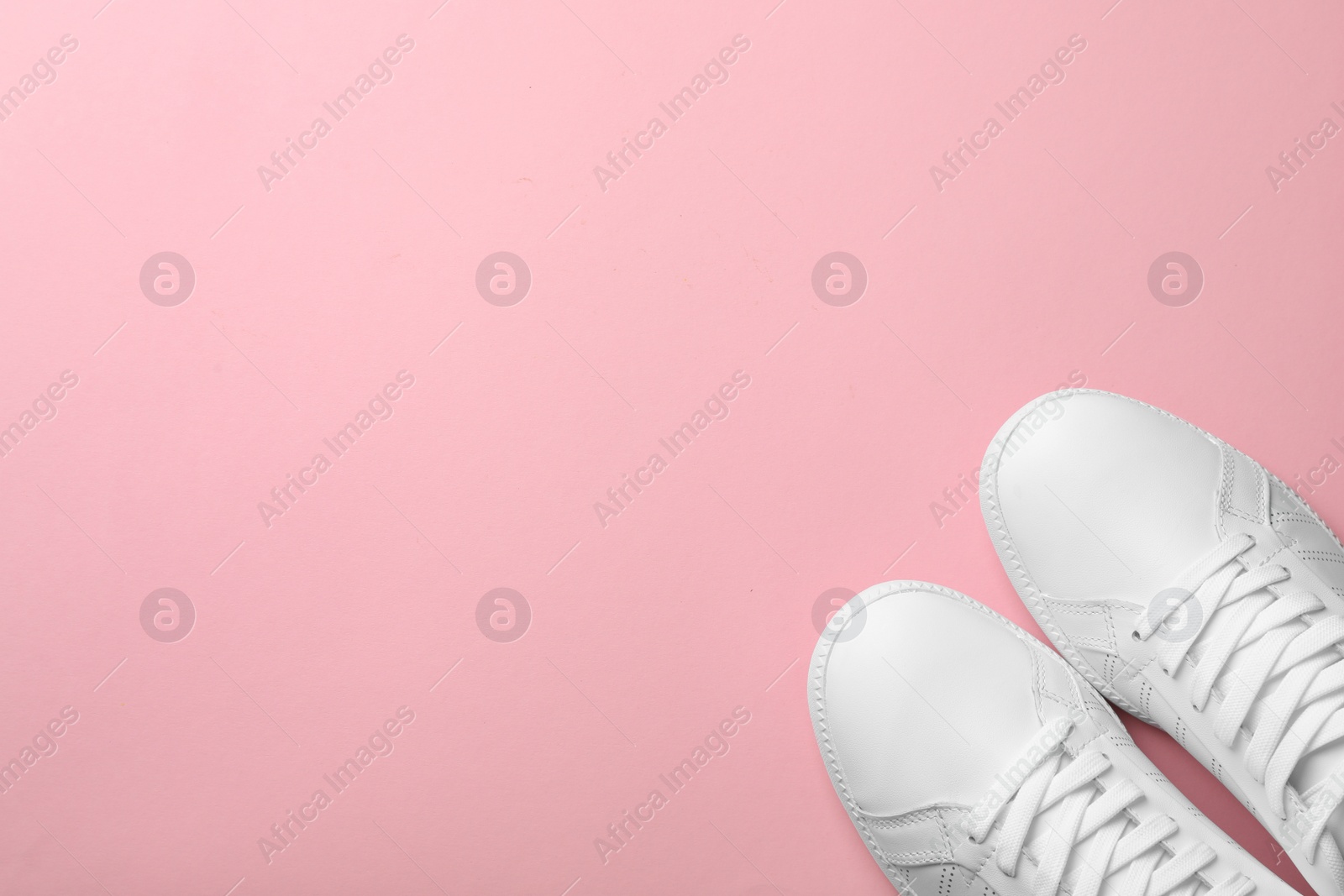 Photo of Pair of sneakers on color background, flat lay. Space for text