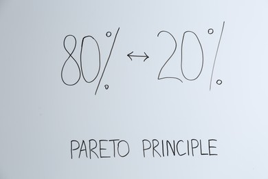 Photo of White board with 80/20 rule representation, closeup. Pareto principle concept