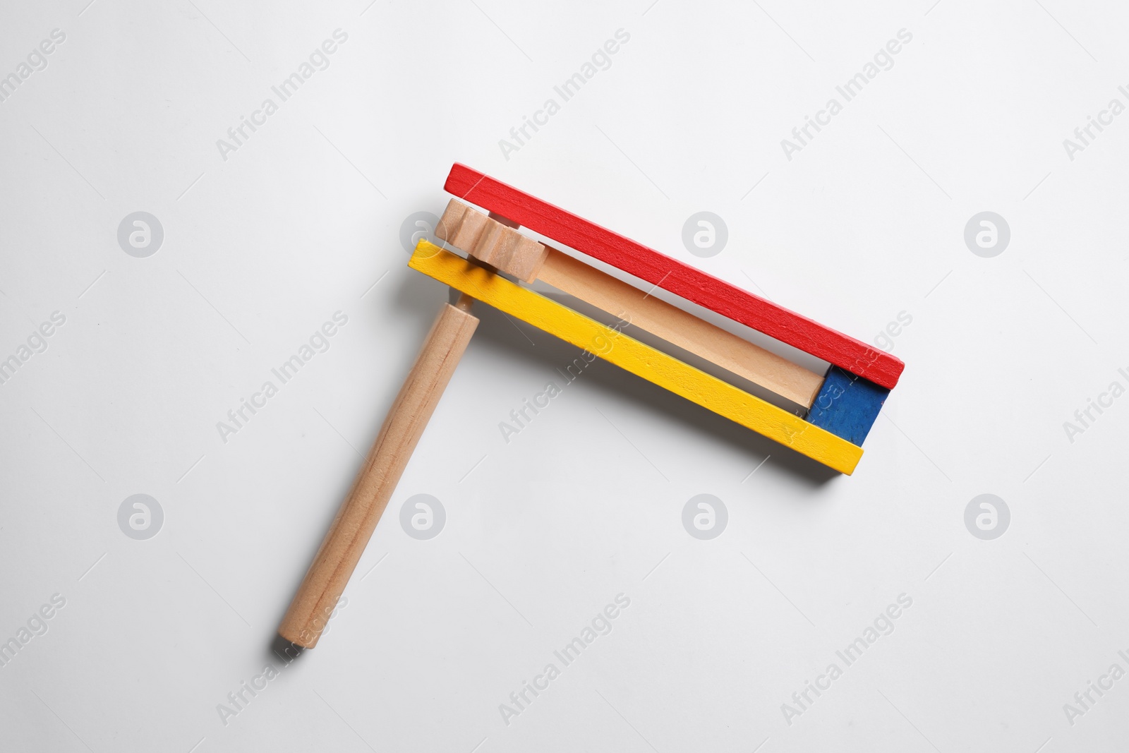 Photo of Wooden spinning ratchet isolated on white, top view. Montessori musical toy