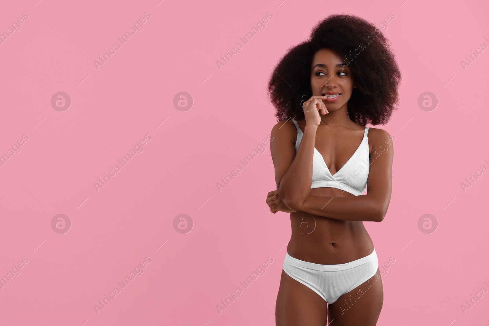 Photo of Beautiful woman in stylish bikini on pink background, space for text