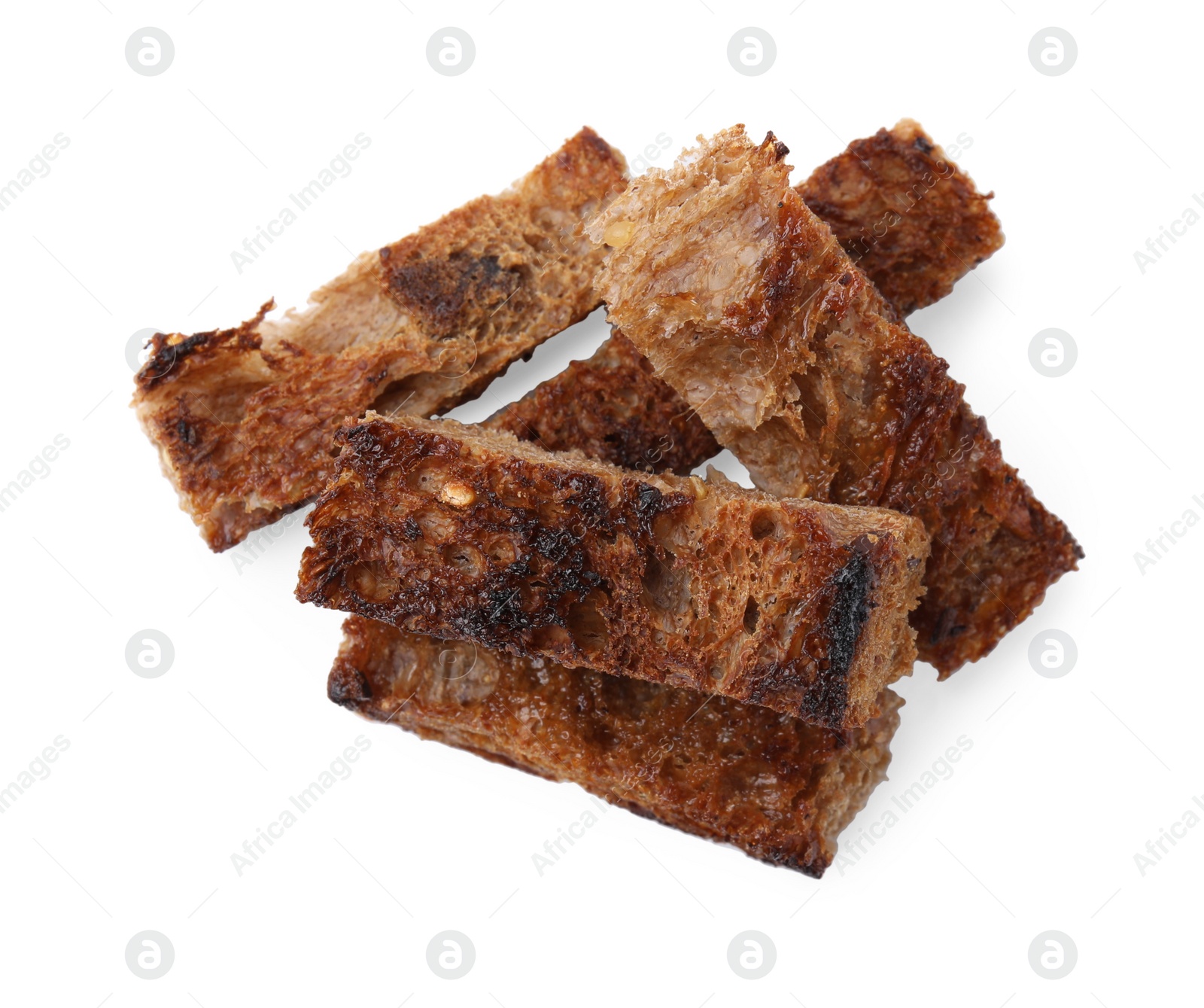 Photo of Heap of crispy rusks isolated on white, top view