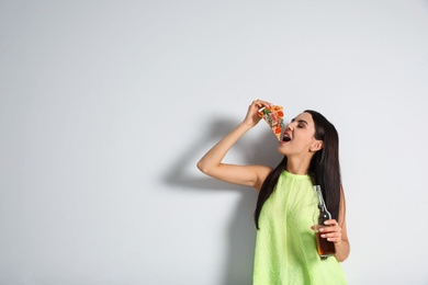 Photo of Happy woman with pizza and beer on white background, space for text