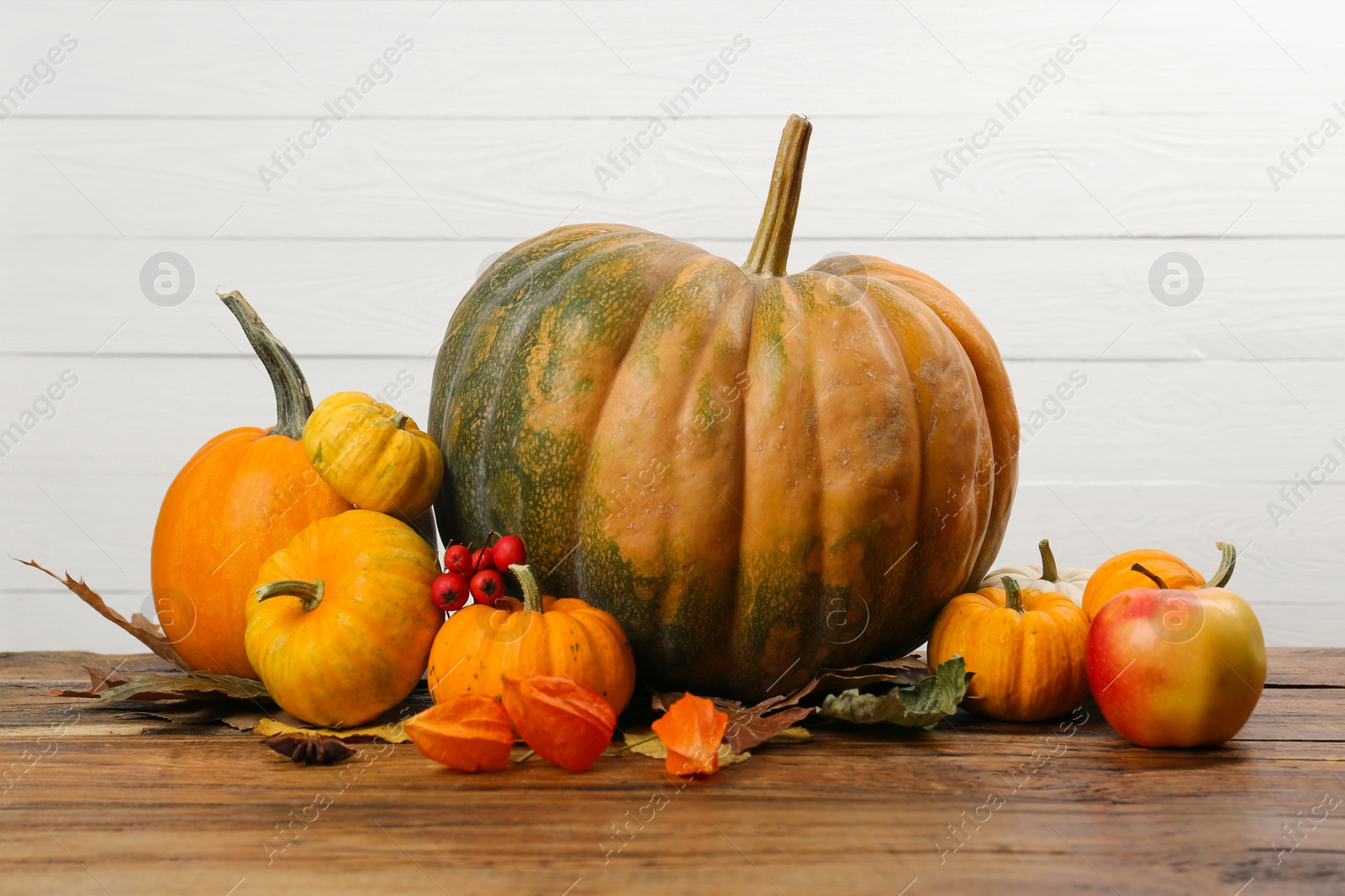 Photo of Happy Thanksgiving day. Beautiful composition with pumpkins on wooden table