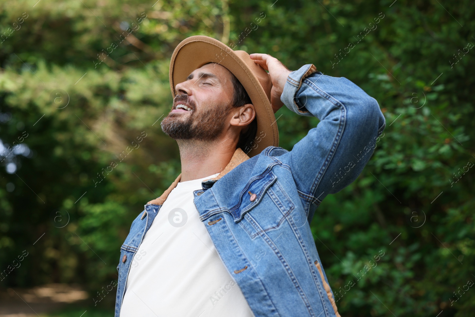 Photo of Feeling freedom. Smiling man enjoying nature outdoors