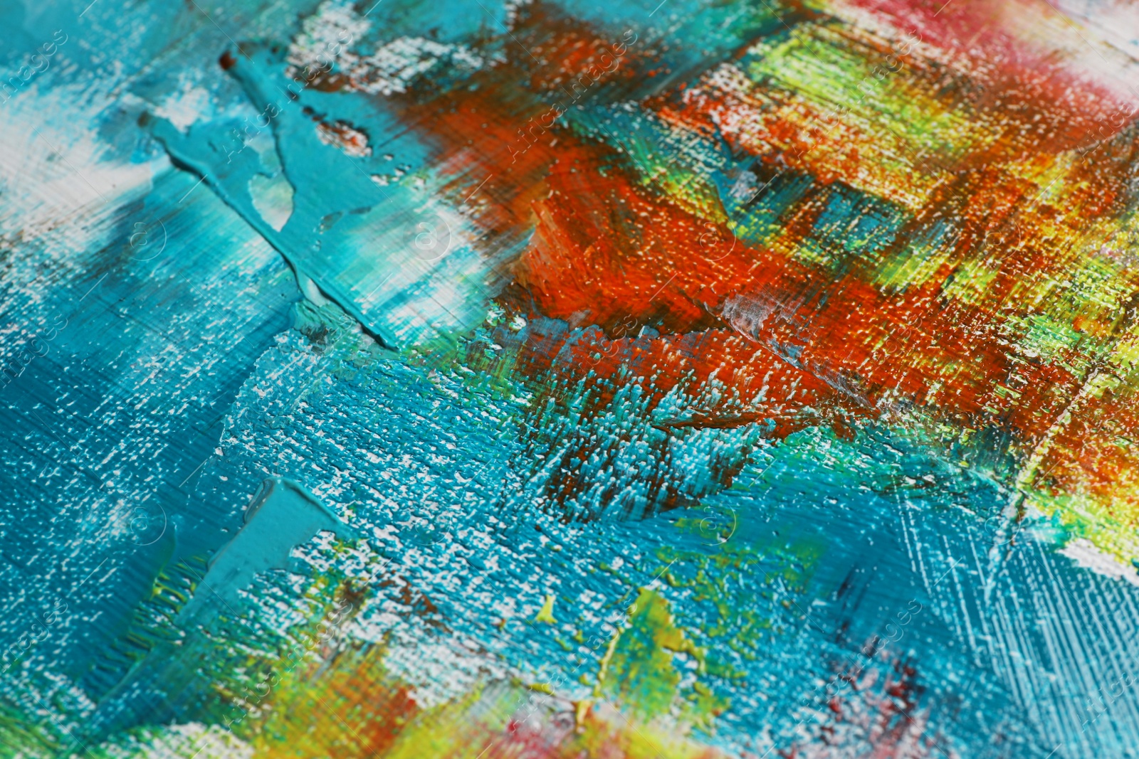 Photo of Strokes of colorful acrylic paints on canvas, closeup