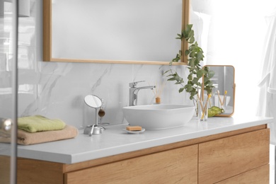 Photo of Modern bathroom interior with vessel sink and big mirror