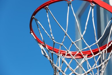 Photo of Basketball hoop with net outdoors on sunny day, closeup