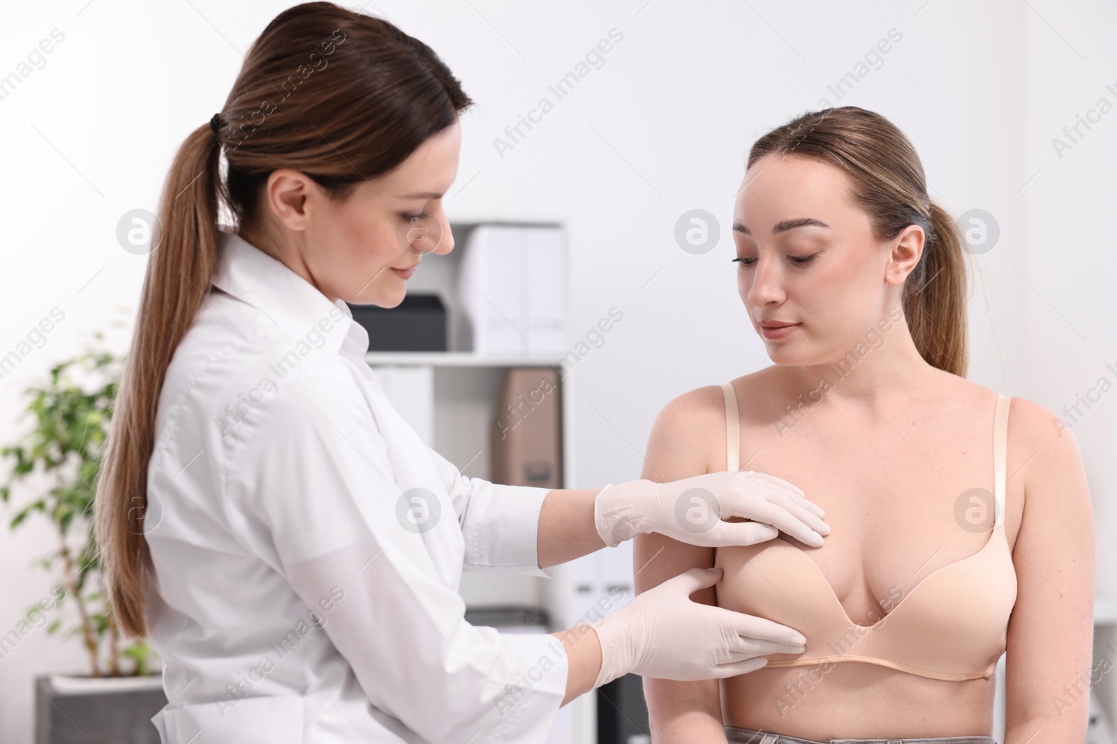 Photo of Mammologist checking young woman's breast in hospital