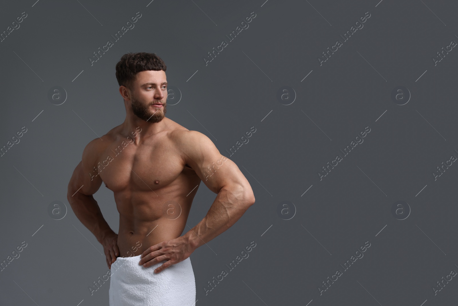 Photo of Handsome muscular man on grey background, space for text. Sexy body