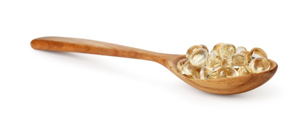 Vitamin capsules in wooden spoon isolated on white. Health supplement