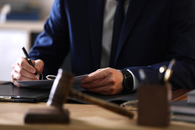 Photo of Male lawyer working at table in office, closeup