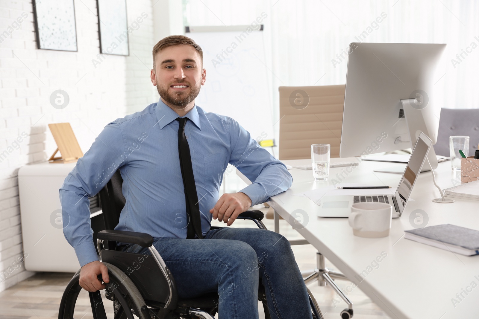 Photo of Portrait of man in wheelchair at workplace