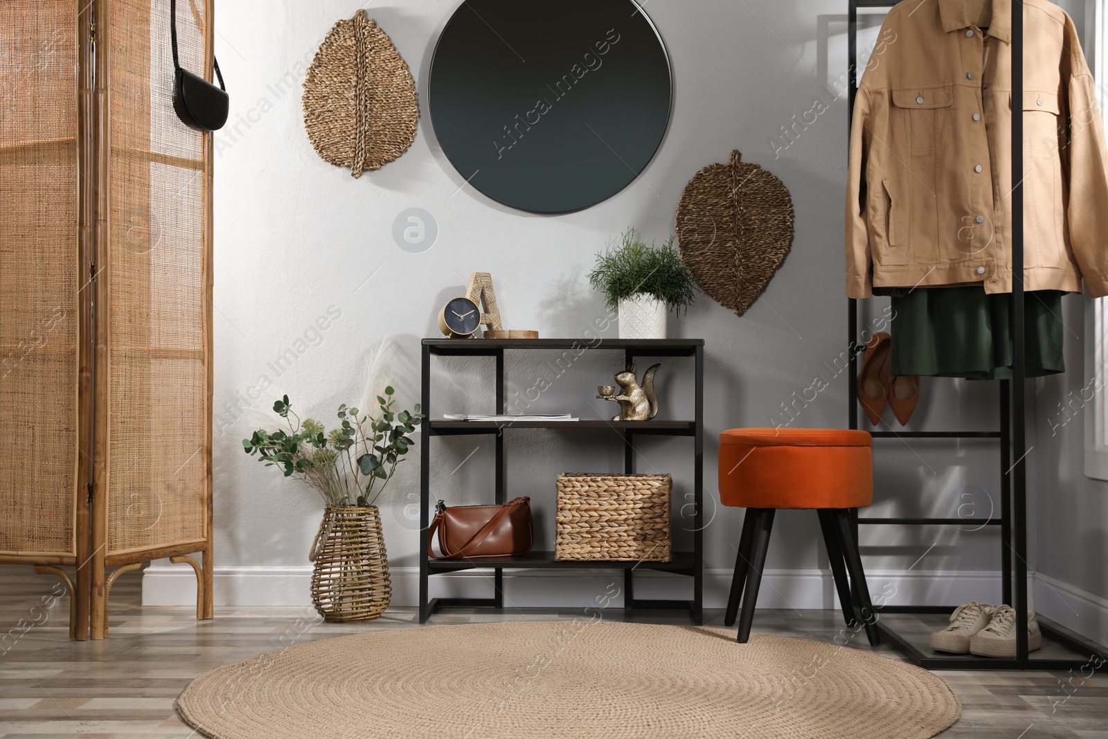 Photo of Stylish room interior with console table and beautiful decor elements