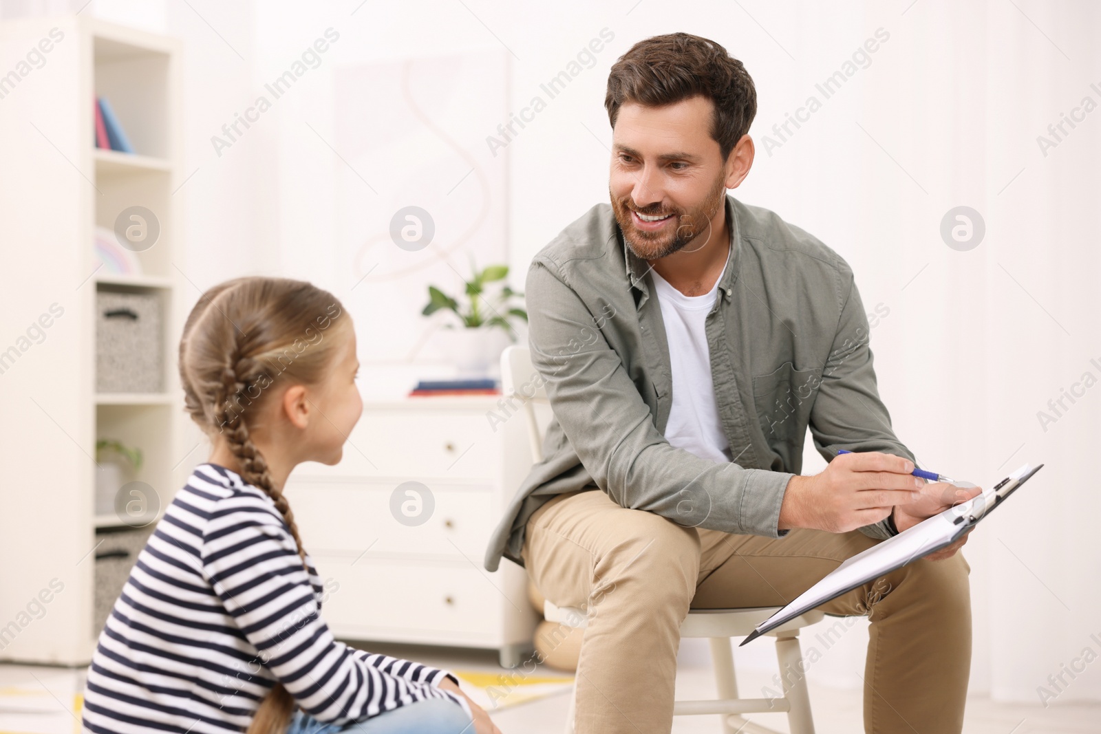 Photo of Dyslexia treatment. Therapist working with girl in room