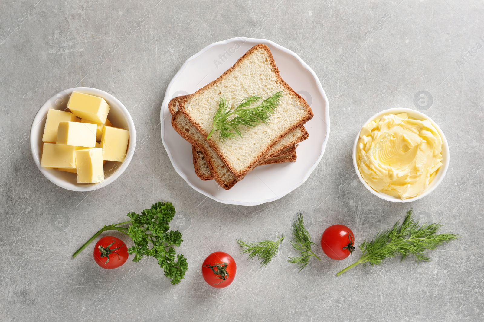 Photo of Flat lay composition with bread and butter on grey background