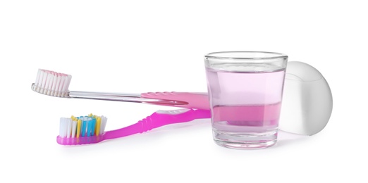 Mouthwash and other items for teeth care on white background