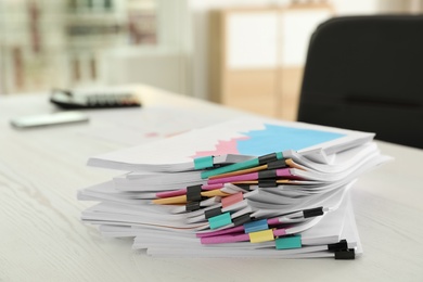 Photo of Stack of documents with paper clips on office table