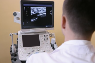 Photo of Mammologist working with ultrasound machine in clinic, closeup