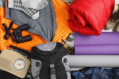Photo of Composition with sleeping bags and camping equipment as background
