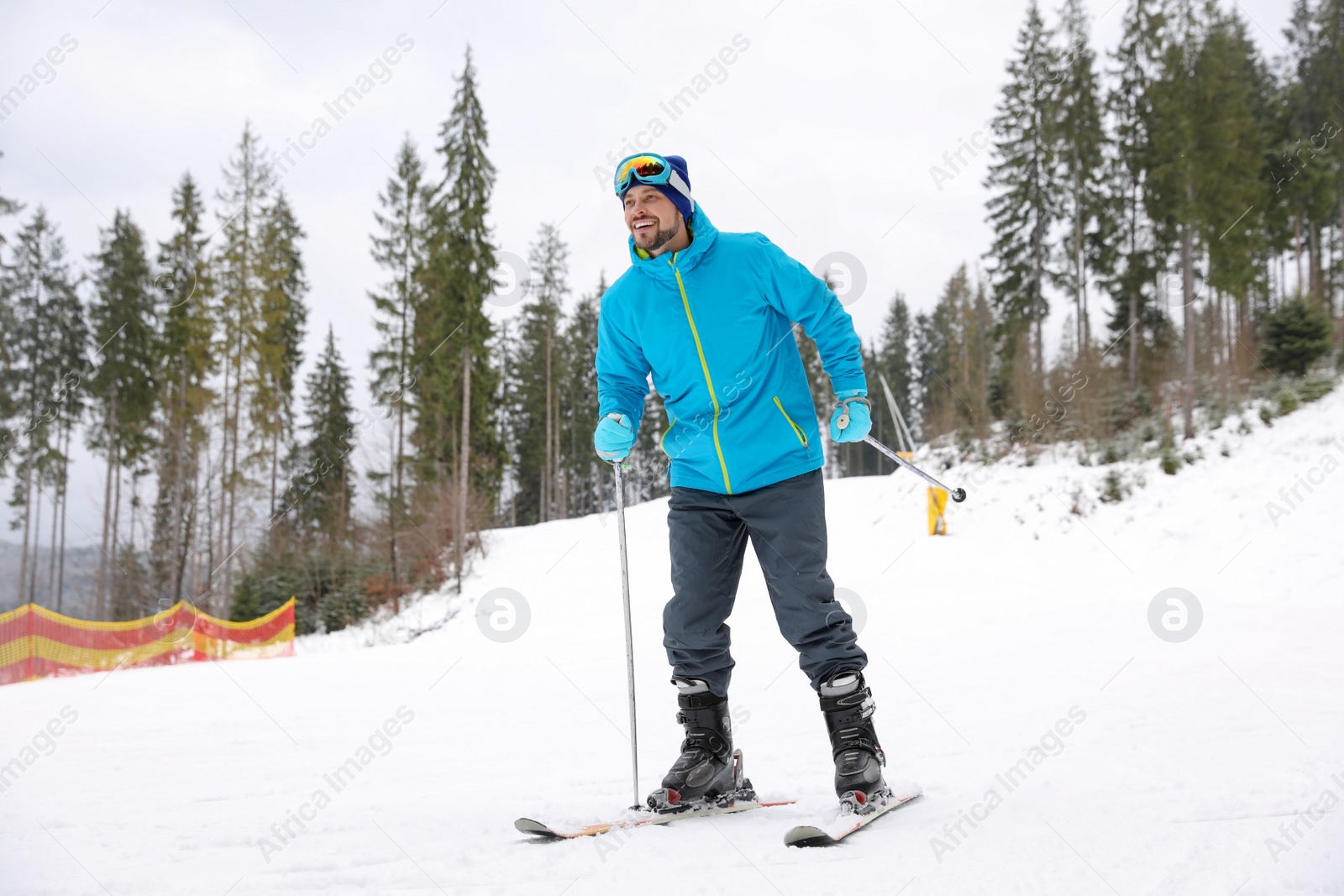 Photo of Male skier on slope at resort. Winter vacation