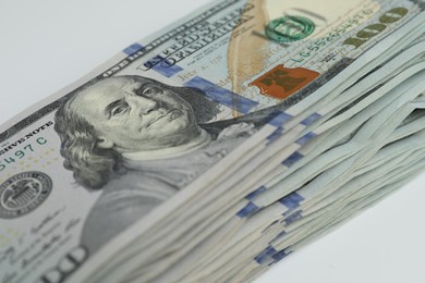 Photo of Money exchange. Dollar banknotes on white background, closeup