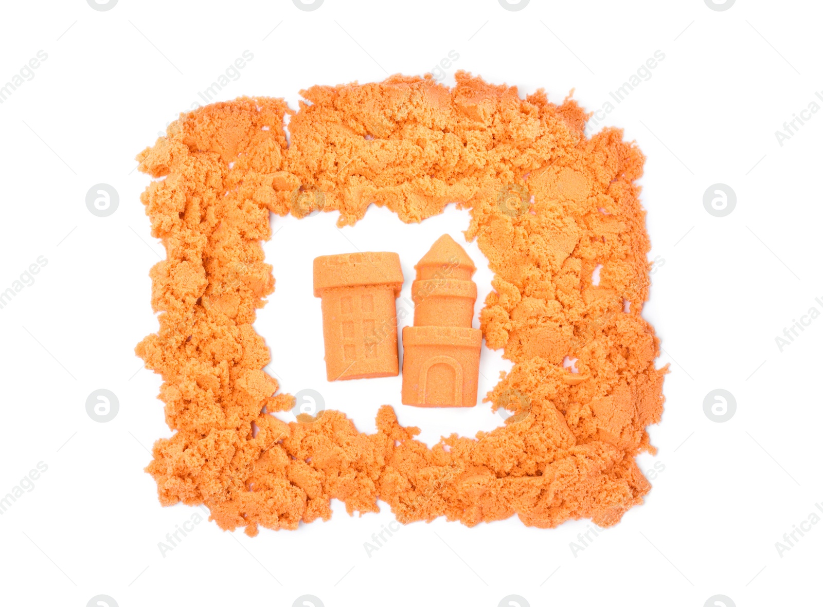 Photo of Castle and tower made of kinetic sand on white background, top view